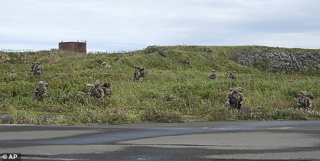 U.S. Army soldiers maneuver through the thick terrain of Shemya Island, Alaska, as part of a force projection operation to the remote island in the North Pacific Ocean Sept. 13.