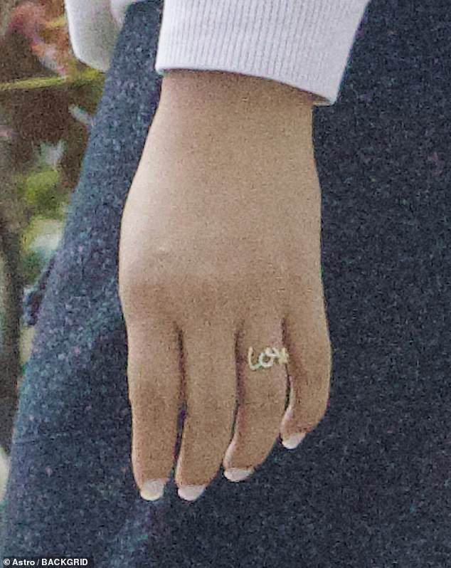 She wore the gold 'Love' accessory on her ring finger, although a source told TMZ it was not a gift from Diddy, who legally changed his name to Love in 2021.