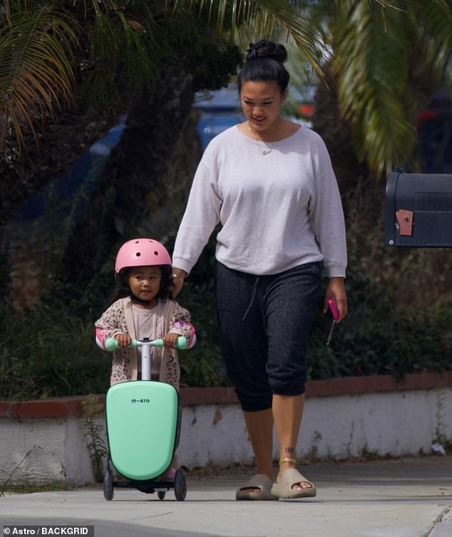 She was seen taking care of her daughter while the little girl enjoyed a scooter ride.