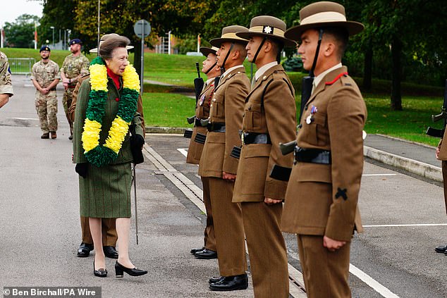 Princess Anne is shown inspecting the guard of honour: members of the regiment who perform ceremonial duties.