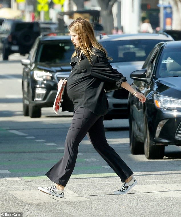 Katherine added some sparkle to her maternity look with a pair of classic black and white checkered Vans.