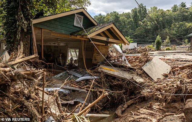 A destroyed house with a car underneath in Chimney Rock, North Carolina