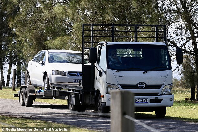 A truck towing a white Holden sedan arrived at the property on Tuesday.