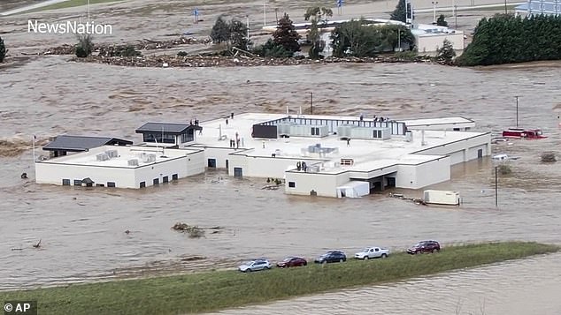 People are seen on the roof of Unicoi County Hospital in Erwin, Tennessee.