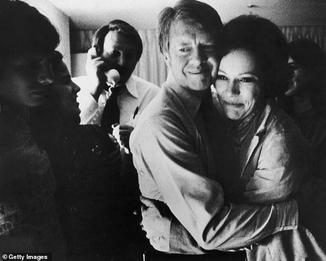 Democratic presidential candidate Jimmy Carter hugs his wife Rosalynn after receiving the latest news of his victory in the national general election on November 2, 1976.