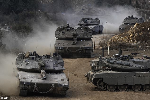 Israeli army tanks maneuver in a concentration area in northern Israel, near the border between Israel and Lebanon.