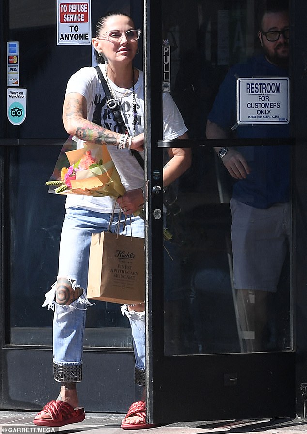 Shara carried a colorful bouquet as the loved-up duo left the Hollywood restaurant on Sunday.