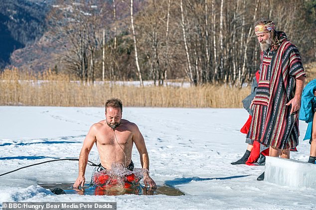 He taught celebrities how to take control of their bodies and mental health with sub-zero ice challenges. In the photo, Hof in a poncho watches Alfie Boe take the step.