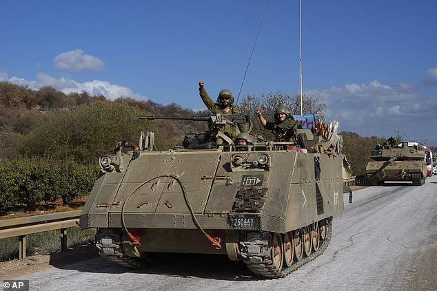 Israeli soldiers in a moving armored vehicle in northern Israel near the Israel-Lebanon border