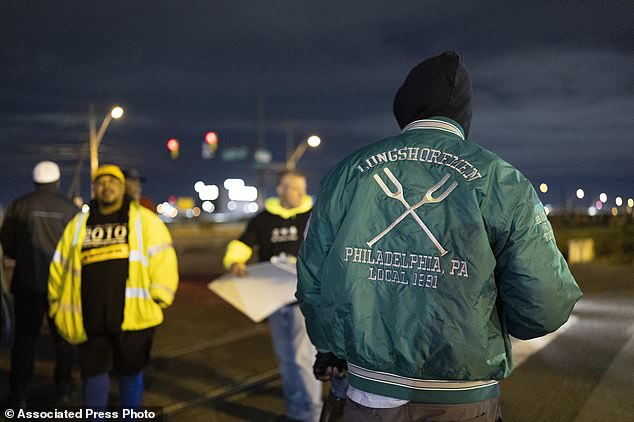 Philadelphia longshoremen gathered outside the Packer Avenue Marine Terminal port begin striking as their contract expires at midnight Tuesday, Oct. 1, 2024. (AP Photo/Ryan Collerd)