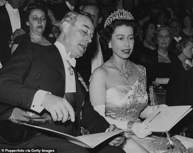 The late Queen pictured speaking to Louis Mountbatten, 1st Earl Mountbatten of Burma, in March 1958.