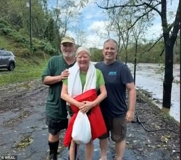 Worth and her husband Phil, center and left, lost all their belongings when their home sank into flood waters.