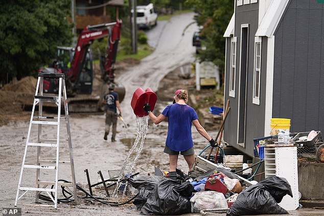 People clean up after Hurricane Helene on Tuesday, Oct. 1, 2024, in Hot Springs, North Carolina.