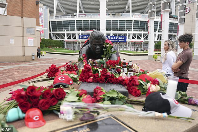 Fans visit the Pete Rose statue outside the Great American Ballpark in Cincinnati