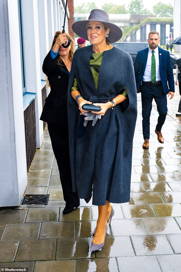 Accompanying the look was a shimmering green satin shirt which she paired with gray suede high heels.