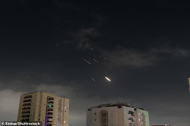 This photo taken on April 14, 2024 shows explosion flares in the sky over Tel Aviv as Israel's anti-missile system intercepts Iran's missiles and drones.