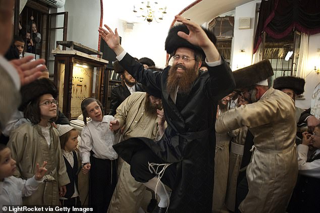 A man dances in a synagogue during the Simchat Torah celebration