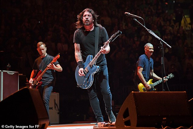 His band Foo Fighters is reportedly 'going on hiatus' amid their affair scandal (Nate Mendel, Dave and Pat Smear pictured on stage in June 2021)