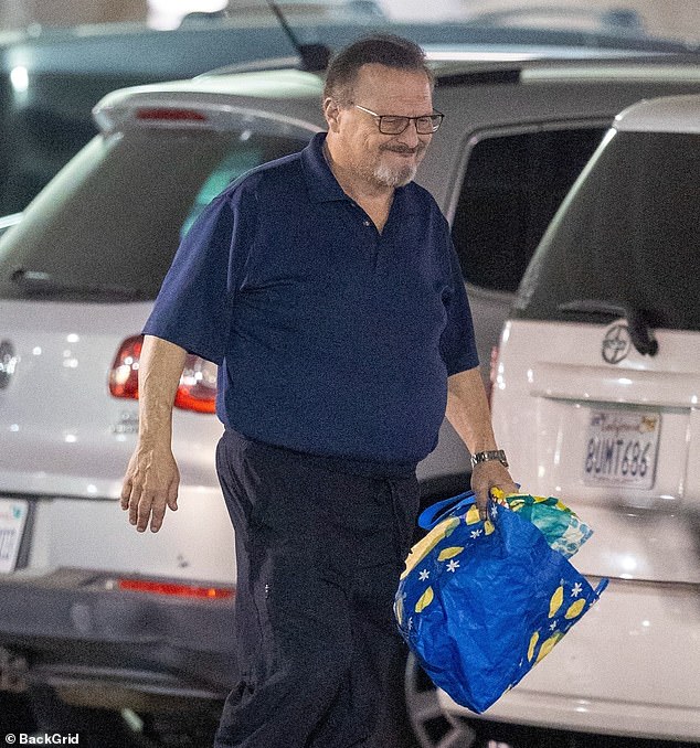 He was photographed crossing a parking lot.