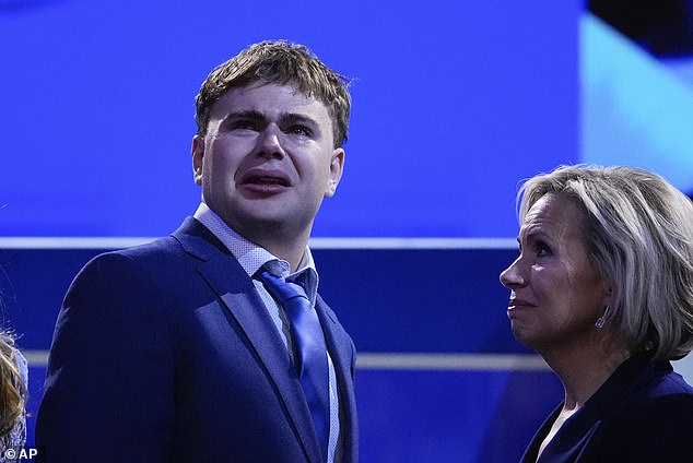 Gus Walz, son of Democratic vice presidential candidate Minnesota Gov. Tim Walz, cries during the Democratic National Convention on Wednesday, Aug. 21, 2024, in Chicago, as his mother Gwen Walz looks on