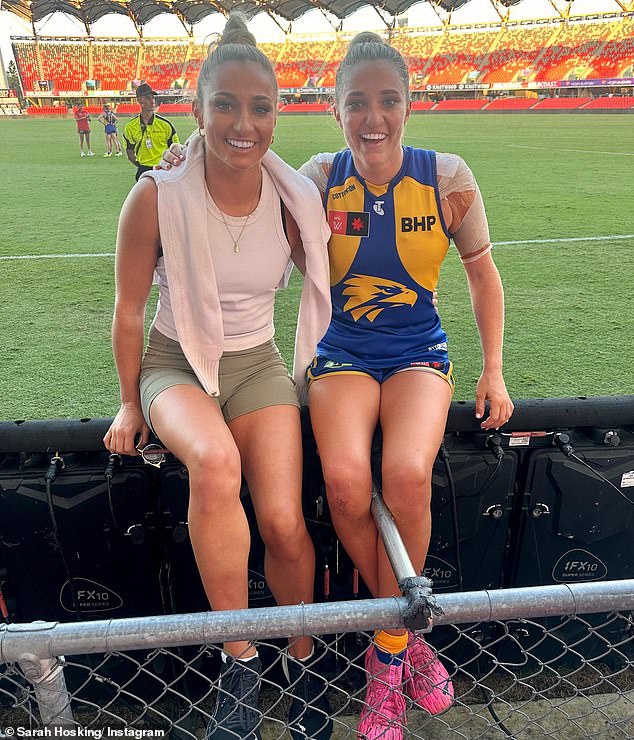 Sarah Hosking (left) is pictured with her twin sister Jess after a recent West Coast Eagles game.