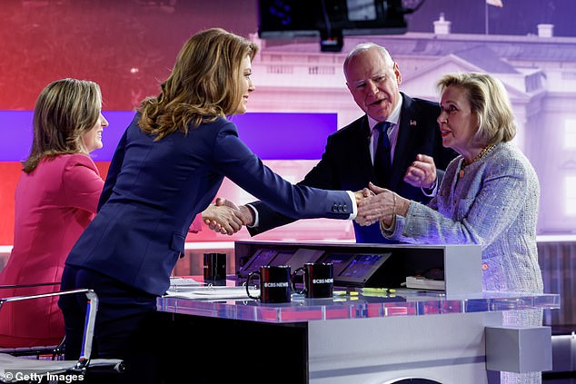 Democratic vice presidential candidate Minnesota Governor Tim Walz and his wife Gwen Walz greet moderators Margaret Brennan (far left) and Norah O'Donnell.