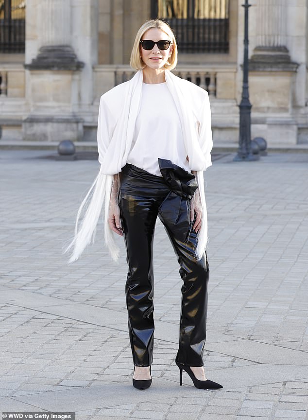 The 55-year-old Australian oozed effortless French elegance in a pair of patent leather trousers that featured a low-cut hips and a daring leather bow.