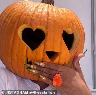 The star uploaded three selfies in the post as she showed off the pumpkin carving and at one point put her hand over her jagged mouth to reveal she was wearing an orange ring.