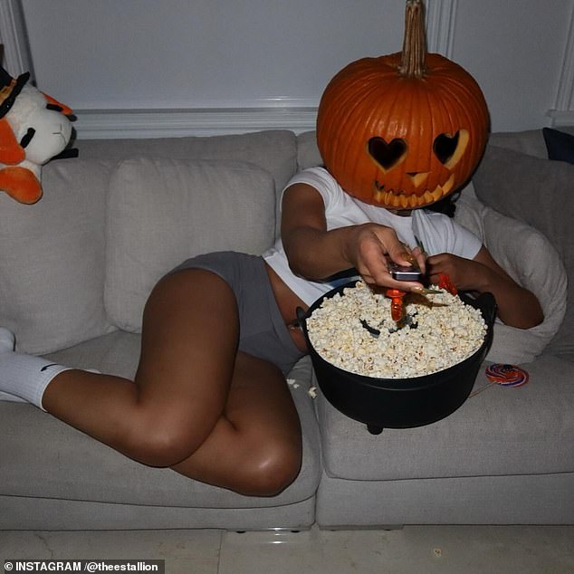 Megan also lounged on a comfy couch with the pumpkin while flipping through channels on the TV.