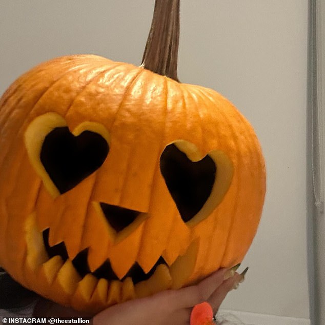 In the images, the artist also showed off the carved pumpkin while nibbling on a large bowl of popcorn.