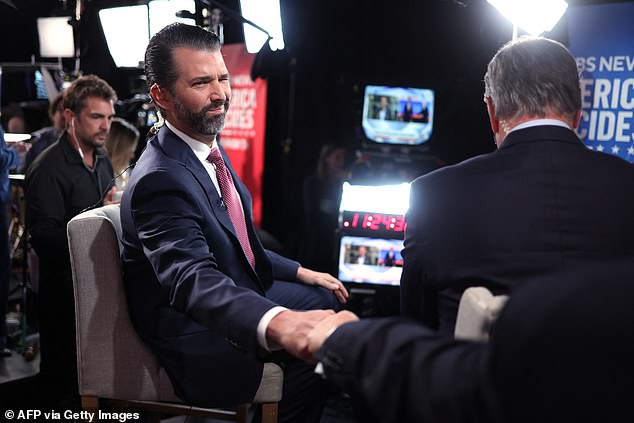 That was the point where the interview became tense, with Trump Jr. then proceeding to blame the attempted assassination of his father on the political environment the media created. PICTURED: Donald Trump Jr. reaches out to greet someone before an interview with a Fox News reporter. in the spin room on tuesday night