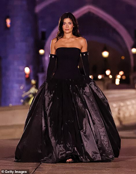 The model channeled her inner villain as she strutted down the runway in a stunning black satin gown.