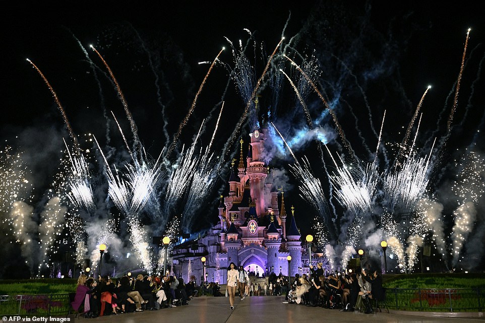 As the models took to the runway, fireworks rained down around Disneyland's most iconic castle.