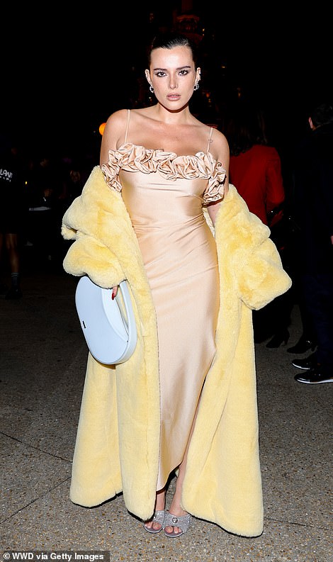 The actress paired her glamorous look with a yellow faux fur coat.