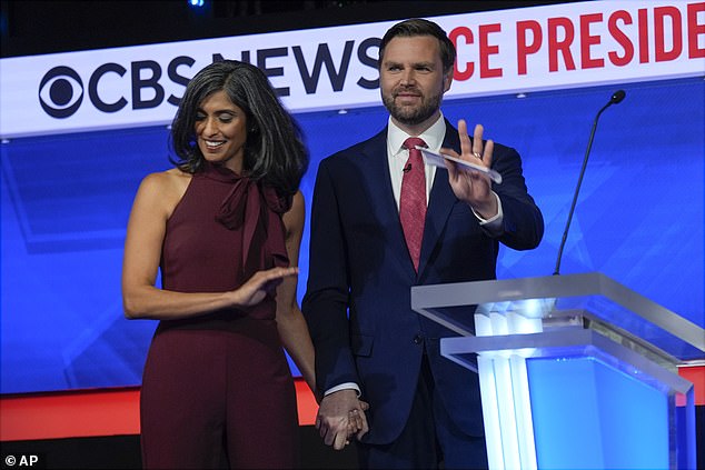 JD Vance holds his wife Usha's hand on stage after his only vice presidential debate with Tim Walz.