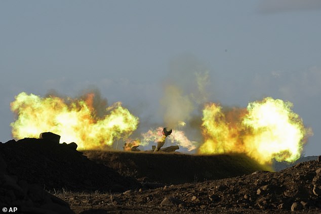 An Israeli mobile artillery unit fires a projectile from the northern border into Lebanon on Wednesday morning.