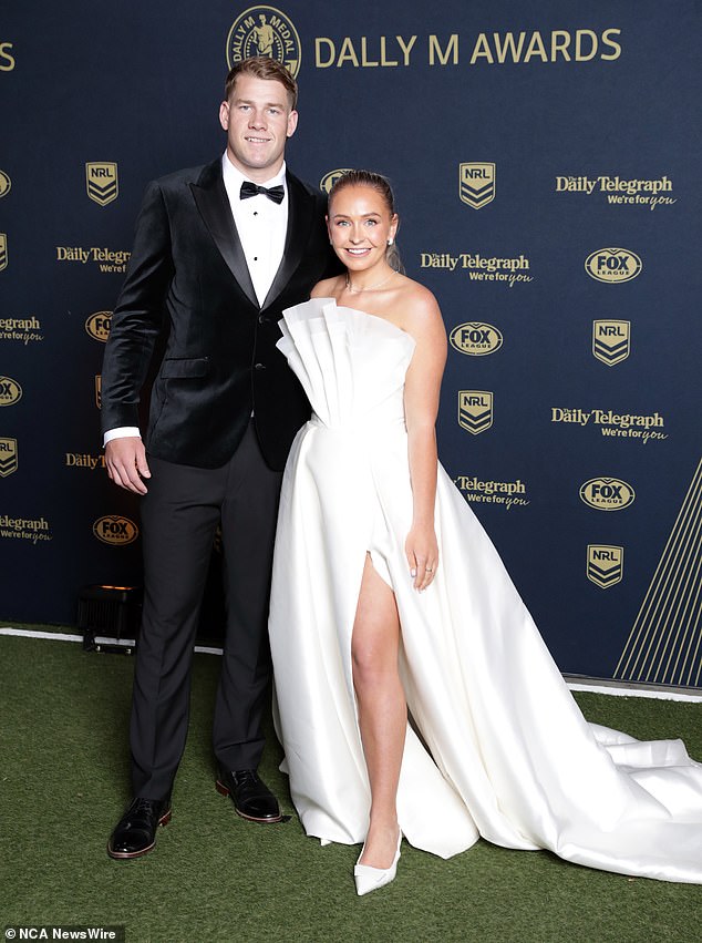 Zoe Warwick, teammate of Bulldogs halfback Matt Burton, arrived in style wearing a spectacularly chic white dress with a sleek front slit and ruffled strapless front.