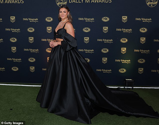 The Roosters' Millie Elliott strutted down the carpet in a beautiful black dress that ensured she stood out from the crowd due to her large size.