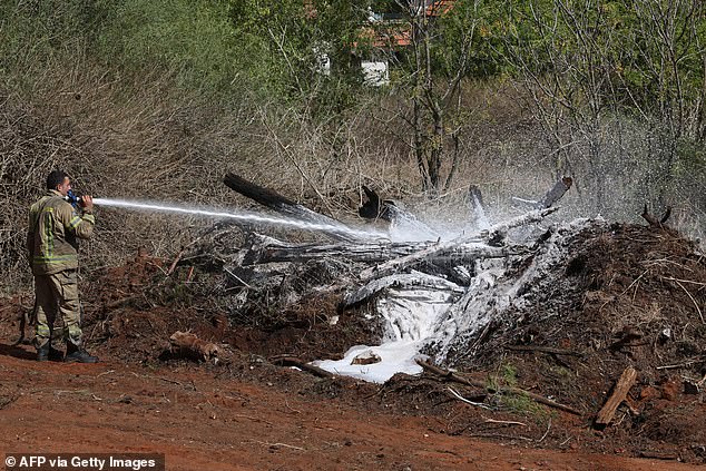 A firefighter uses foam to extinguish the fire in Hod HaSharon after an Iranian missile attack on Israel, October 2, 2024.