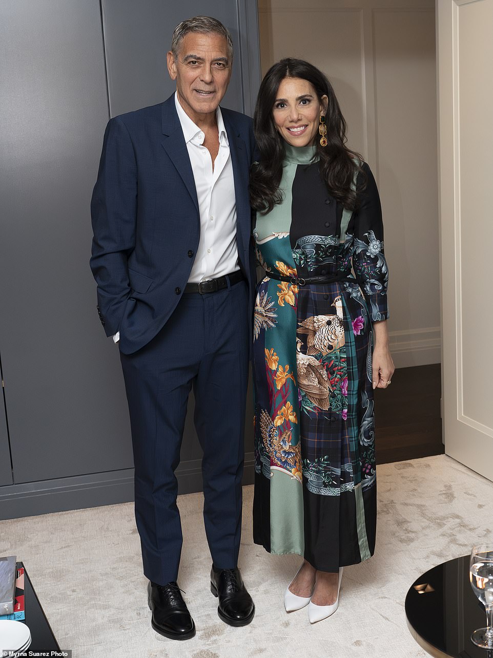 Clooney poses with Tahari, who was wearing a multi-patterned satin dress and white pumps.