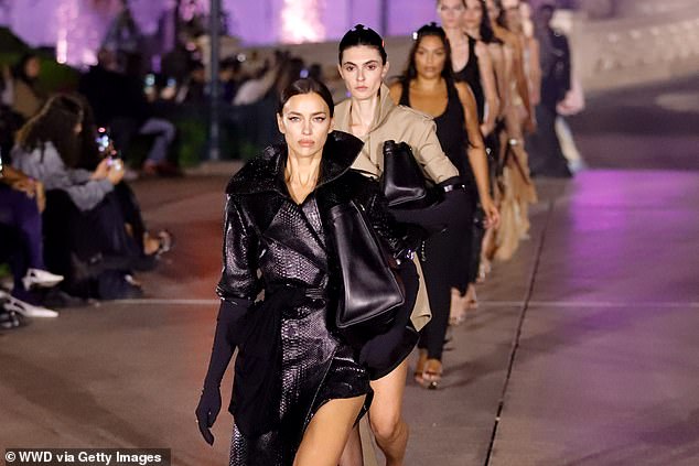 The Russian native looked incredible in the asymmetrical dress, which she paired with a pair of black stilettos and an oversized purse.