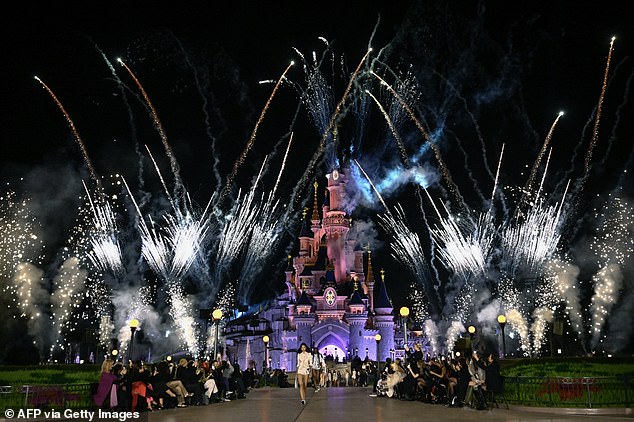 As the models took to the runway, fireworks rained down around Disneyland's most iconic castle.