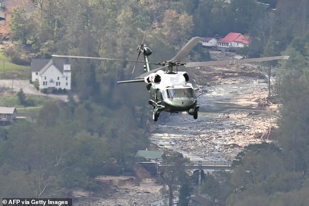 Marine One, carrying US President Joe Biden, flies over a storm-affected area near Asheville, North Carolina, on October 2, 2024.