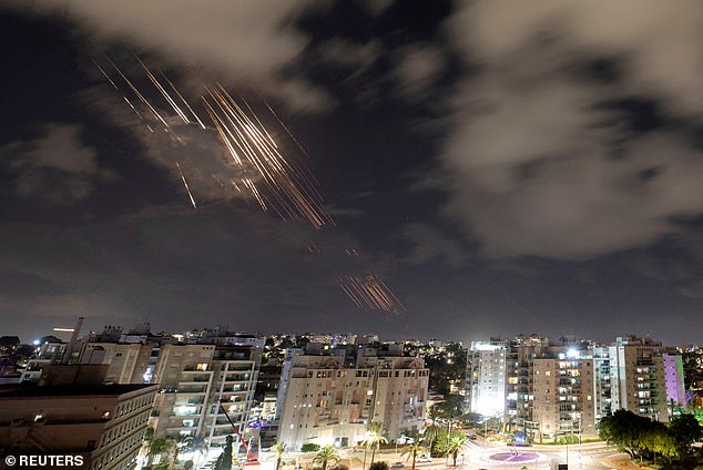 Israel was attacked by a massive barrage of ballistic missiles by Iran overnight (pictured, missiles intercepted by Iran's Iron Dome defense system)