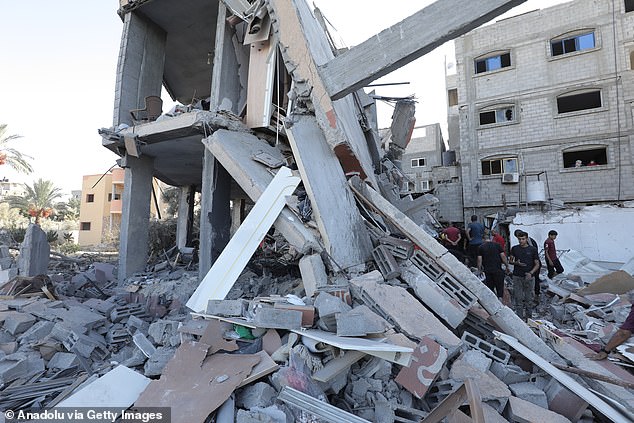 Palestinian residents search through rubble in the Gaza Strip on Wednesday. Arab Americans are drifting away from Democrats amid the Gaza war, despite former President Donald Trump's strong support for Israel.