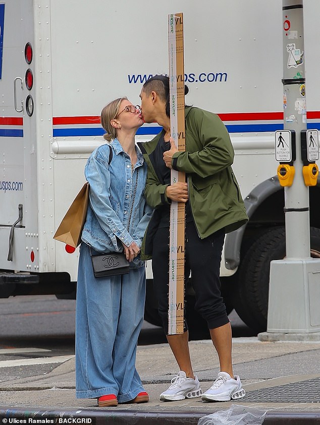 The couple shared a sweet kiss while waiting to cross the street.