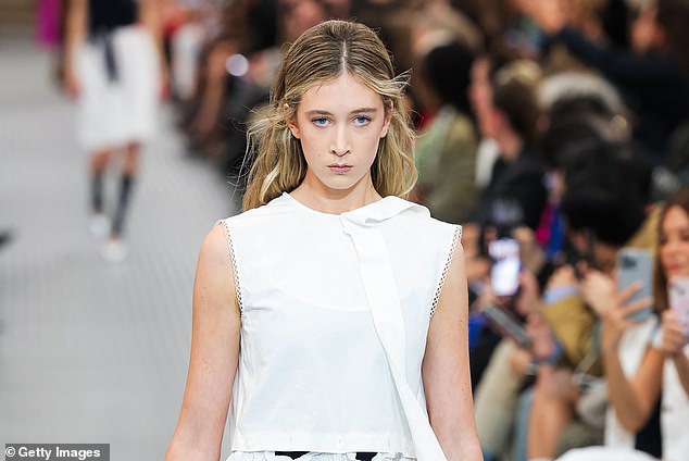 The model cut a stunning figure in a sleeveless white dress with delicate ribbon embellishment from the Italian couture brand.