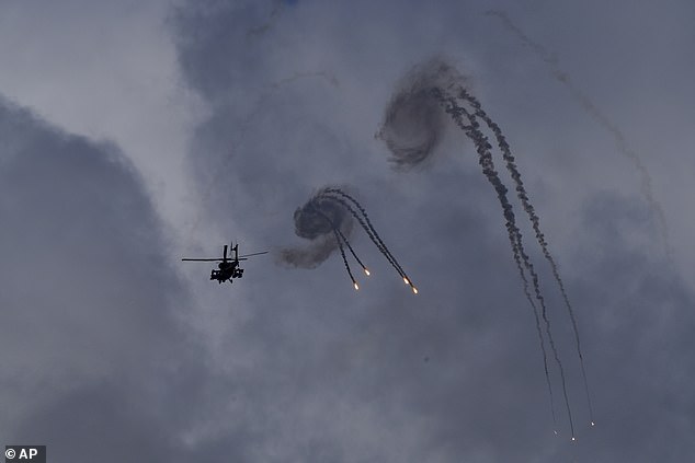 An Israeli Apache helicopter drops flares near the Israel-Lebanon border