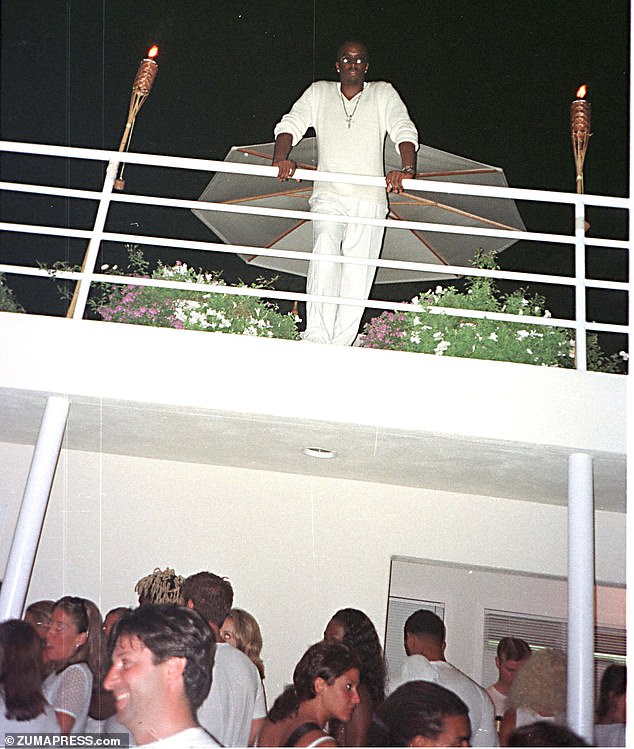 Diddy watches his Labor Day party from the balcony of his East Hampton home in 1998.