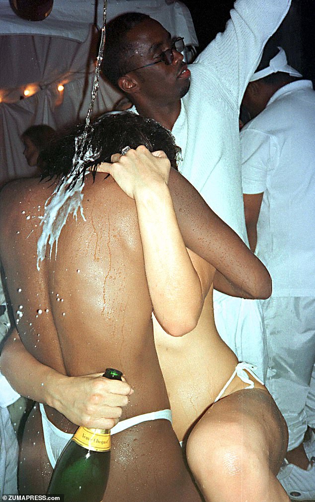 Diddy pours champagne over two nearly naked women at his Labor Day party in 1998.